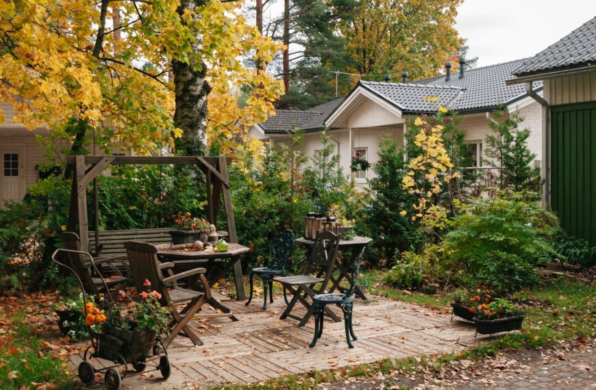 a patio with a table, chairs and a bench