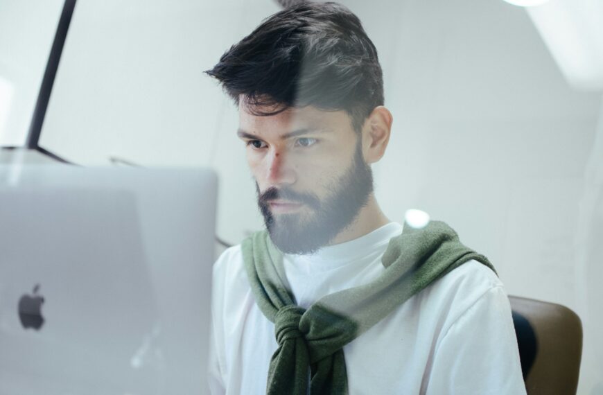 man facing MacBook Pro