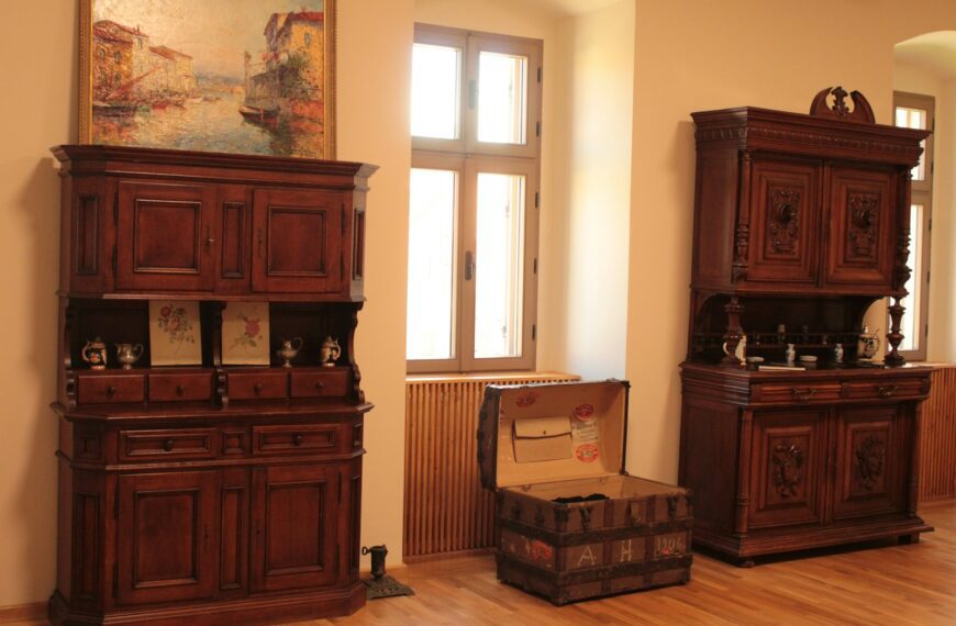 a room with wooden furniture and a painting on the wall