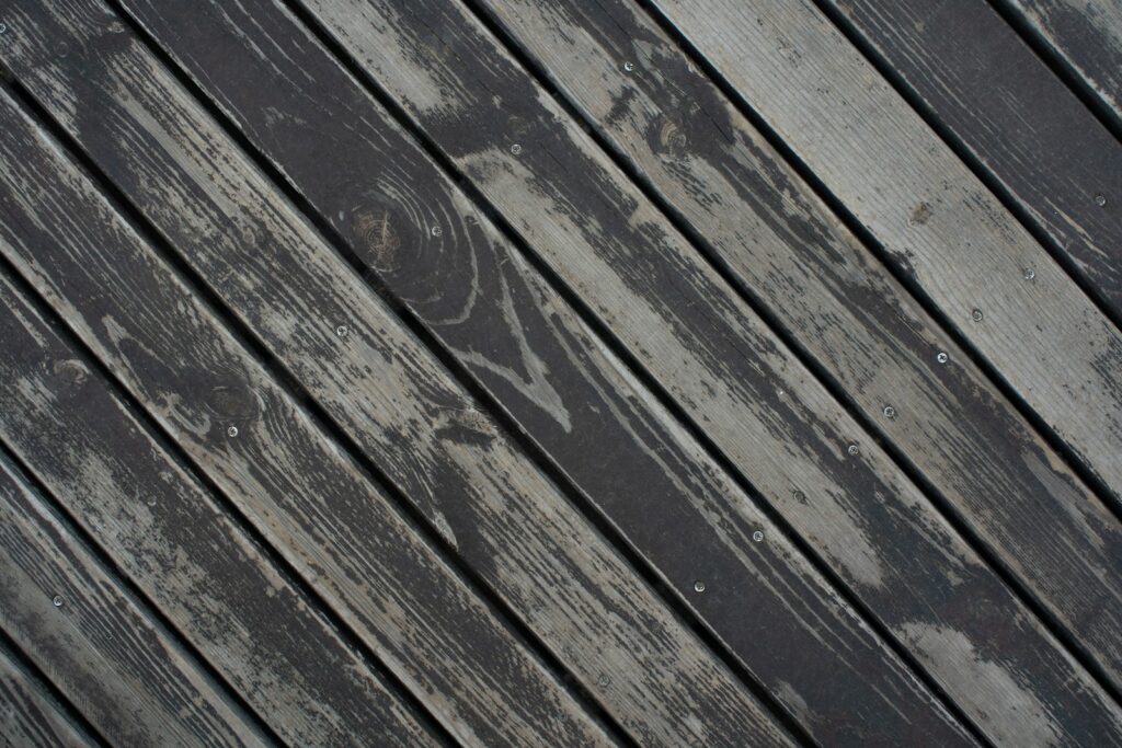 Diagonal weathered wooden planks with a dark gray finish