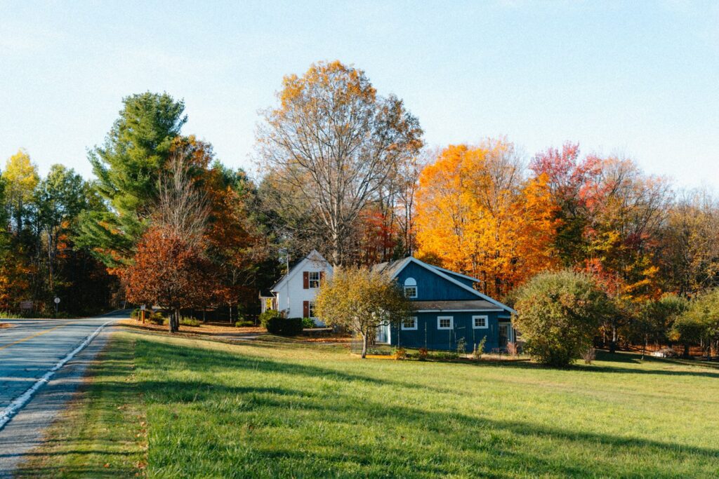 Two houses nestled among colorful autumn trees