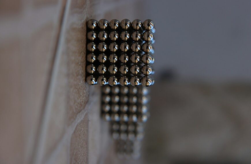 silver beads on brown wooden table