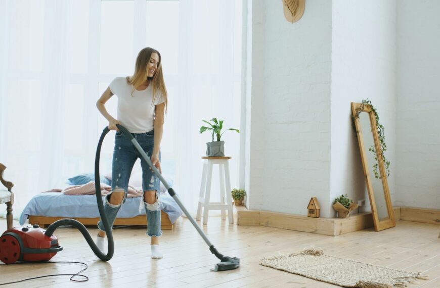 A woman vacuuming a bright, modern living room