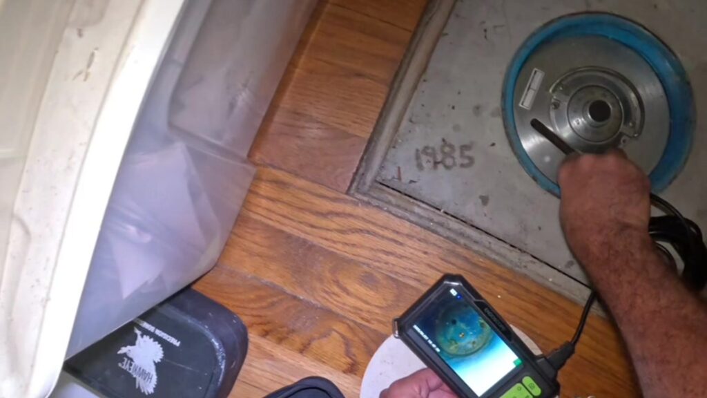 A floor safe dial set into a closet floor with 1985 written in the concrete beside it, from the @vaultcracker TikTok