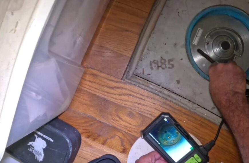 A floor safe dial set into a closet floor with 1985 written in the concrete beside it, from the @vaultcracker TikTok