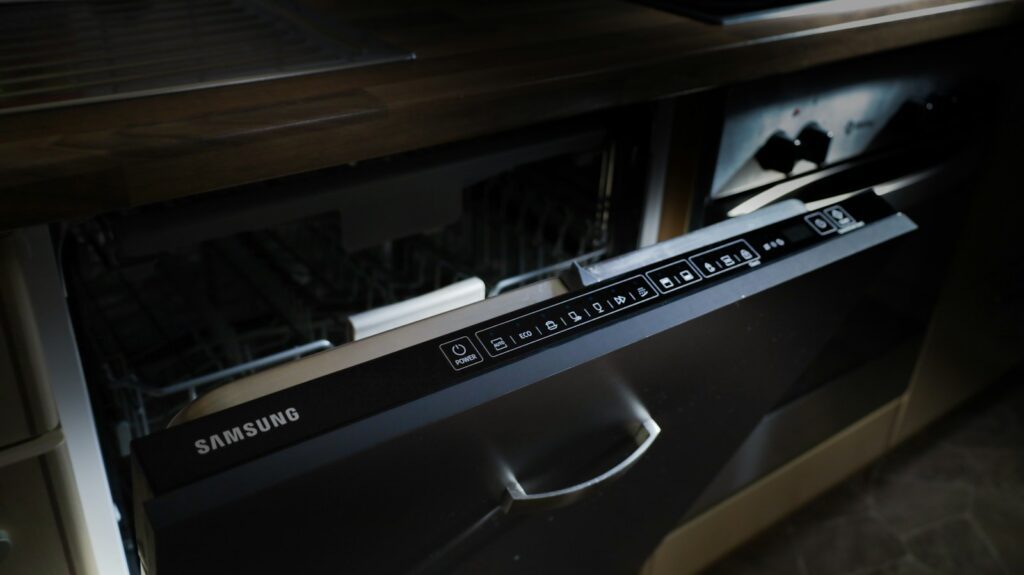 A modern samsung dishwasher drawer built into cabinetry