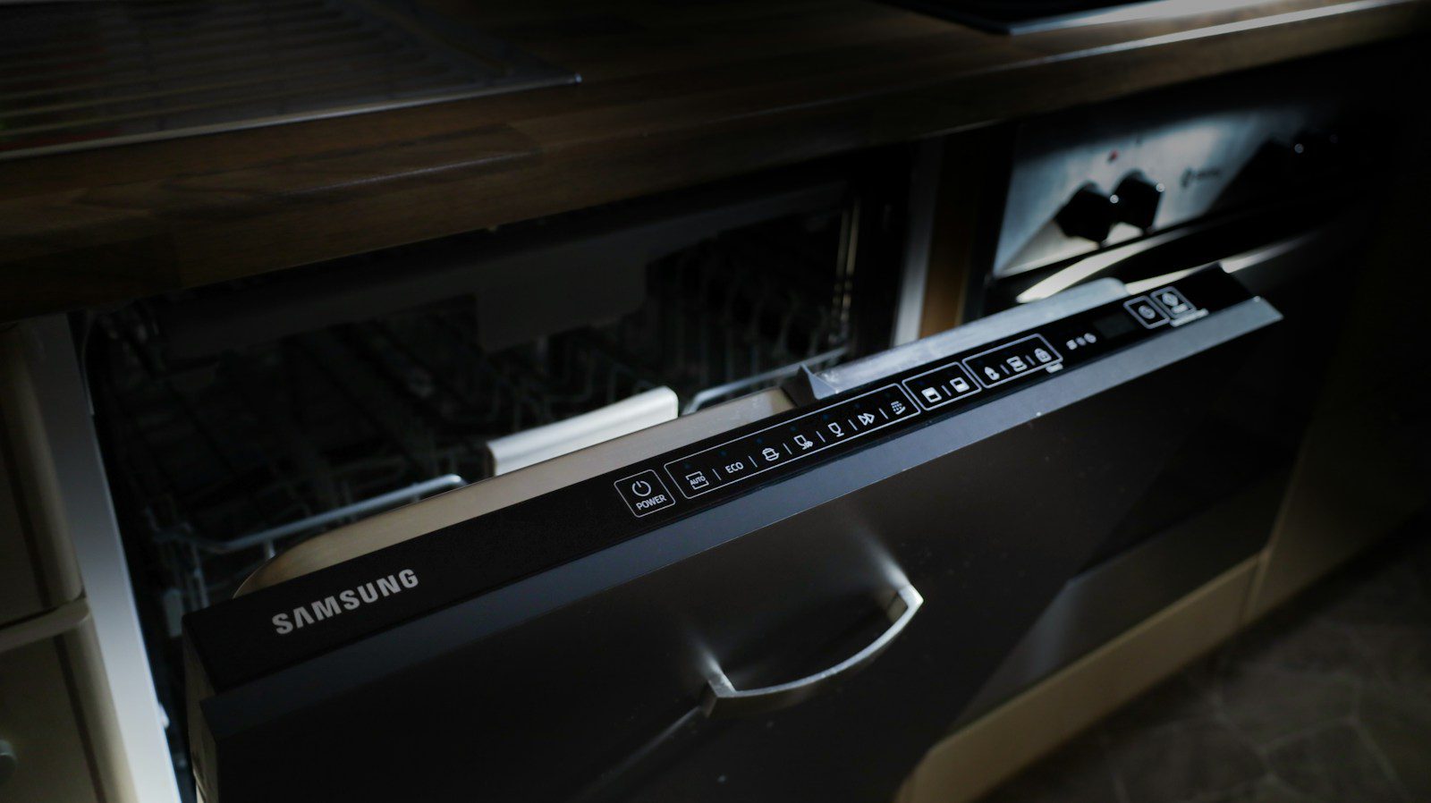 A modern samsung dishwasher drawer built into cabinetry