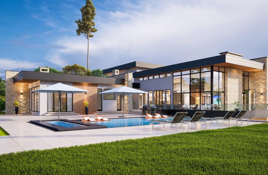 a modern house with a pool and lounge chairs