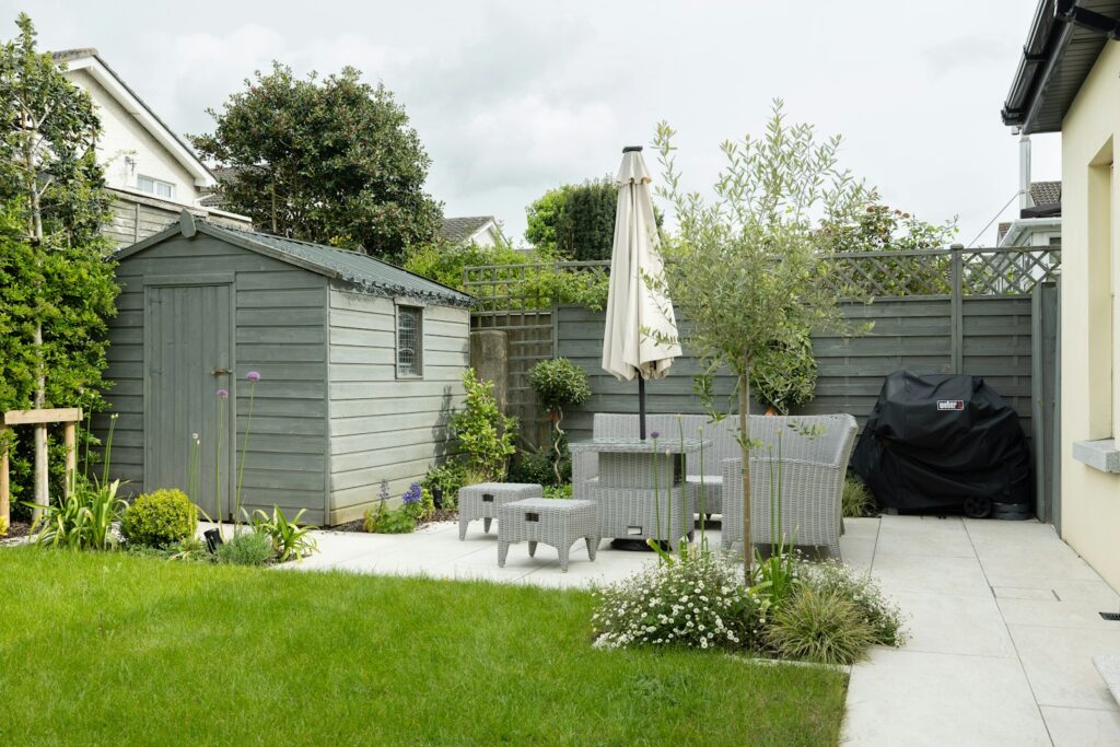 A backyard with a table and chairs and an umbrella