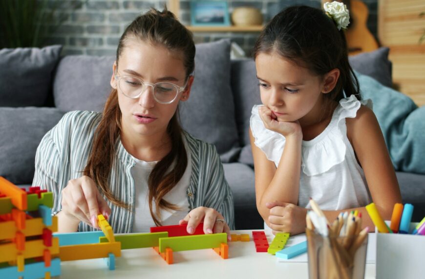 Woman and child building with colorful blocks