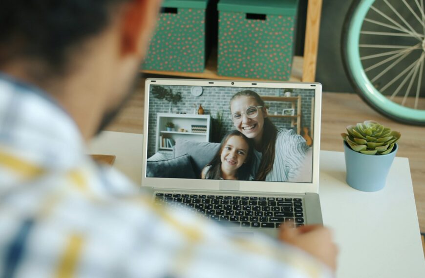 Man video calls with a woman and child