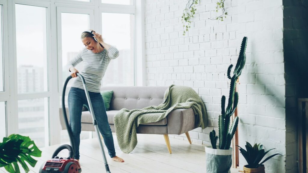 Woman vacuuming and cleaning a bright modern living room