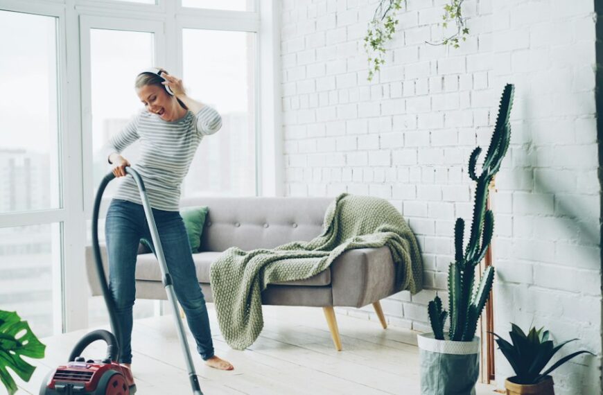 Woman vacuuming and cleaning a bright modern living room