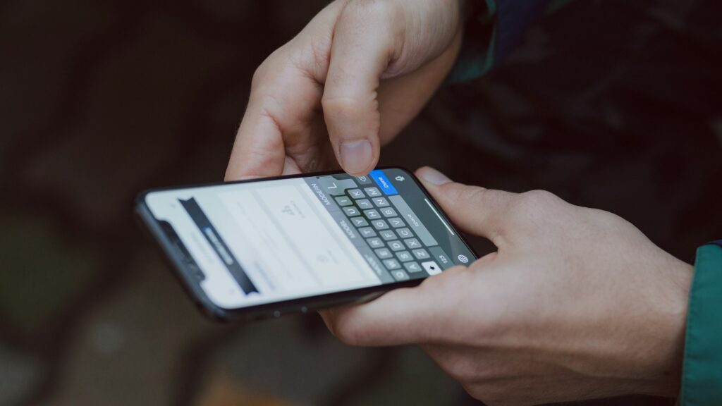 A person typing a message on a smartphone.