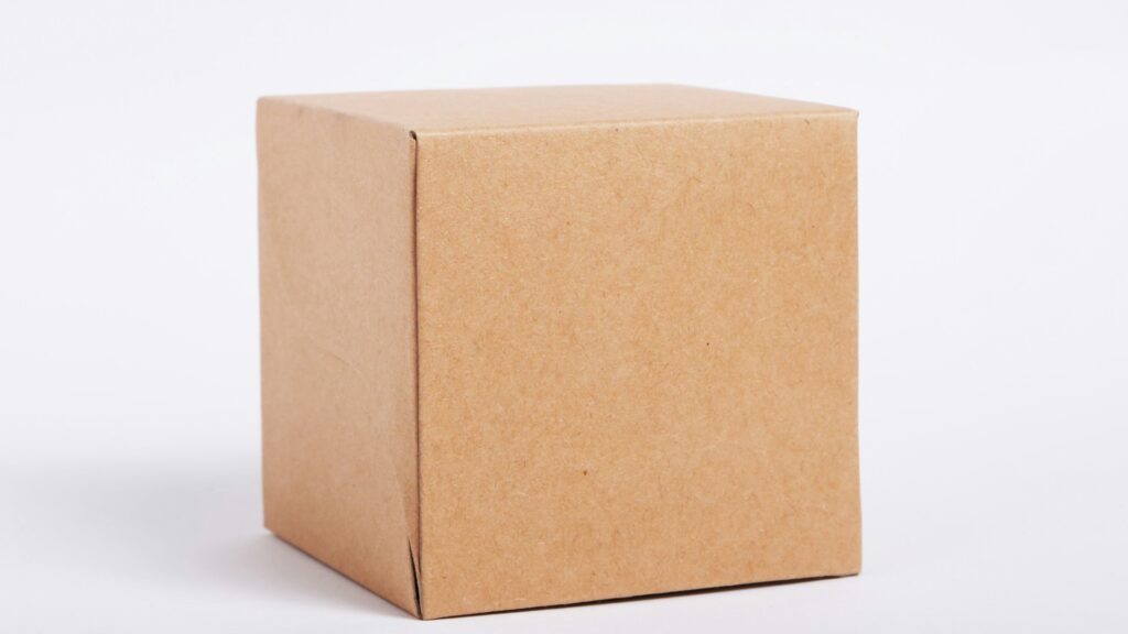 A plain cardboard shipping box on a white surface.
