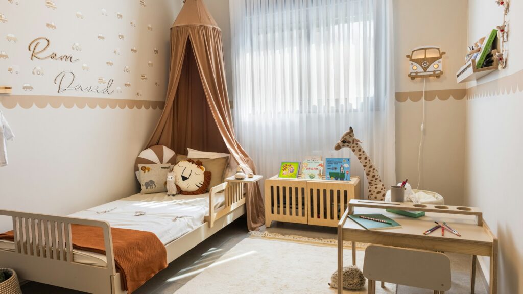 A cozy child's bedroom with a bed and a small desk.