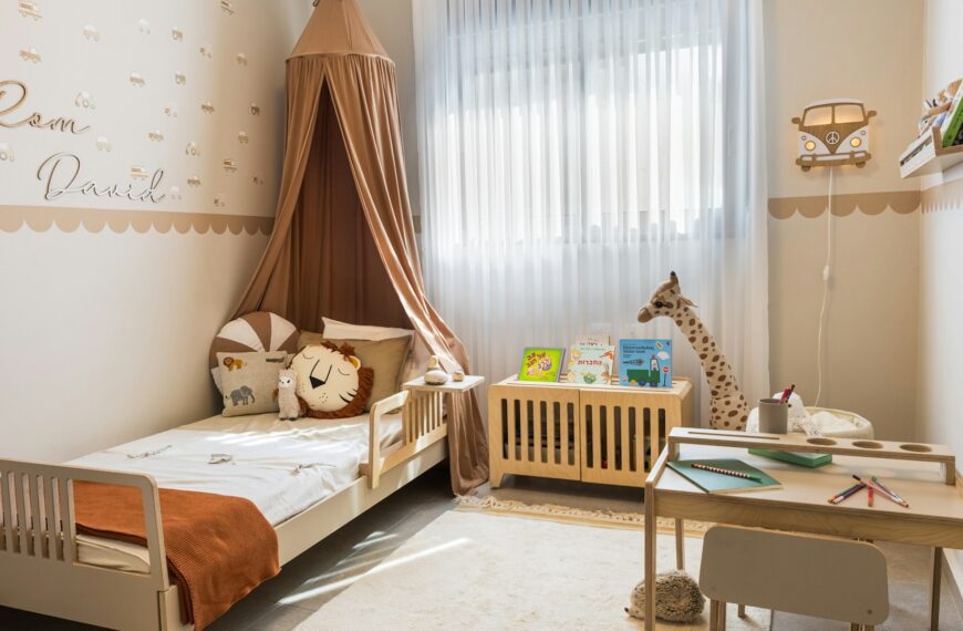 A cozy child's bedroom with a bed and a small desk.