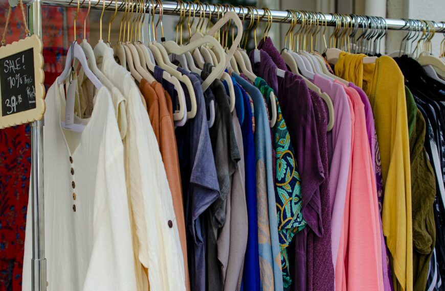 Clothes hanging on a rack in a secondhand shop.