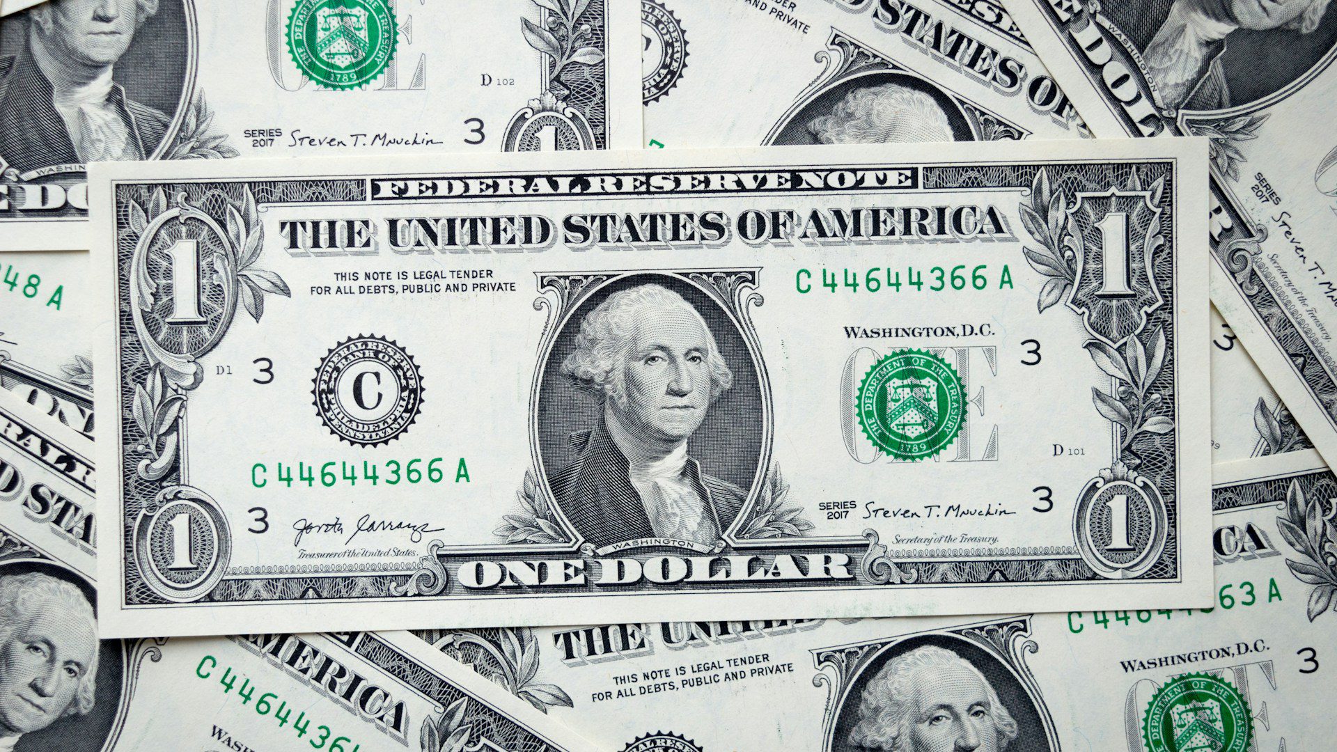 A pile of one dollar bills.