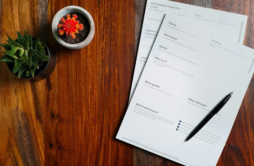 Printed forms and a pen on a wooden table for donation records.