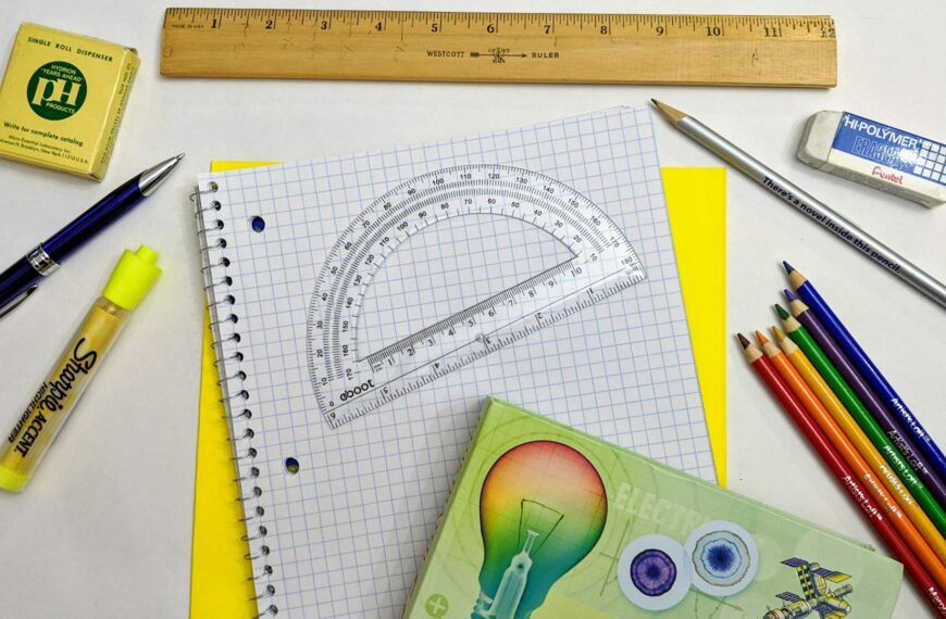 Back to school supplies laid out on graph paper.