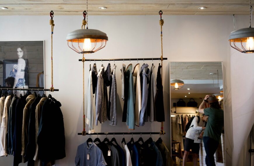 A clothing boutique with garments on hanging racks.