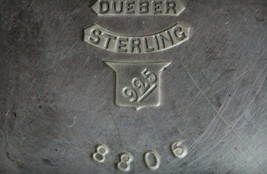 A close-up of a maker's mark stamped into sterling silver, reading Dueber Sterling 925 (Unsplash photo by Anne Nygård).