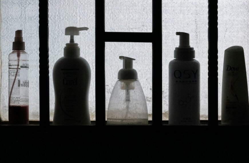 Unsplash photo by Lingchor showing three toiletry bottles on a black wooden shelf