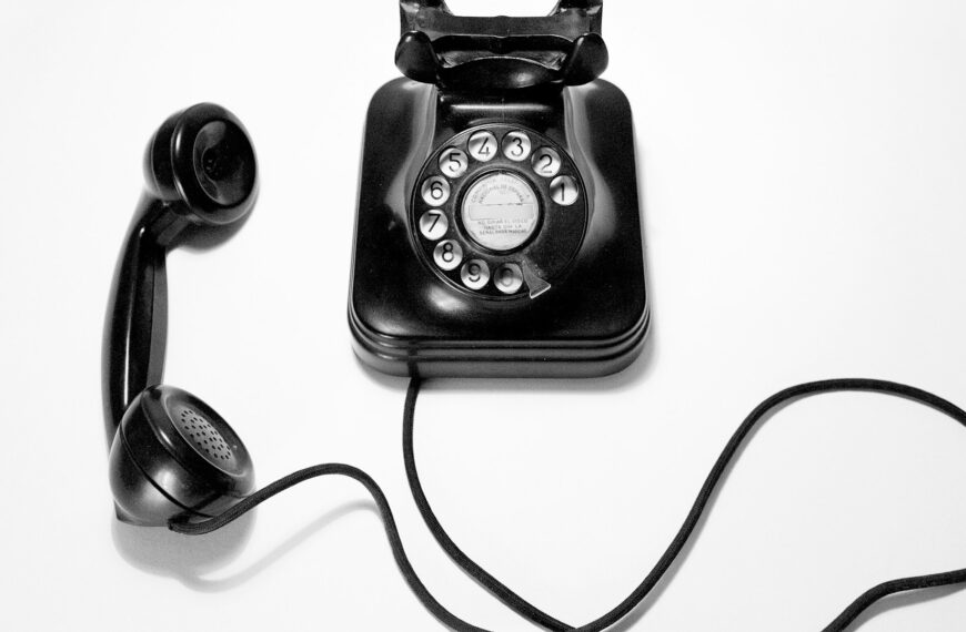 Unsplash photo by Quino Al showing a black rotary dial phone on a white surface