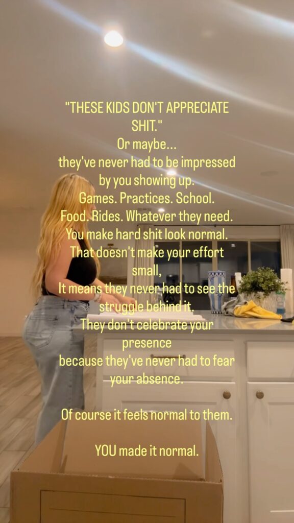 A woman with long blonde hair in a black tank top and jeans packs a cardboard box at a white kitchen counter, with yellow text over the frame about kids not appreciating what parents do (still from the creator's Instagram video)