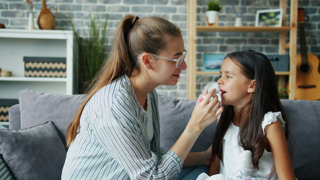 Mother gently comforting her young daughter at home