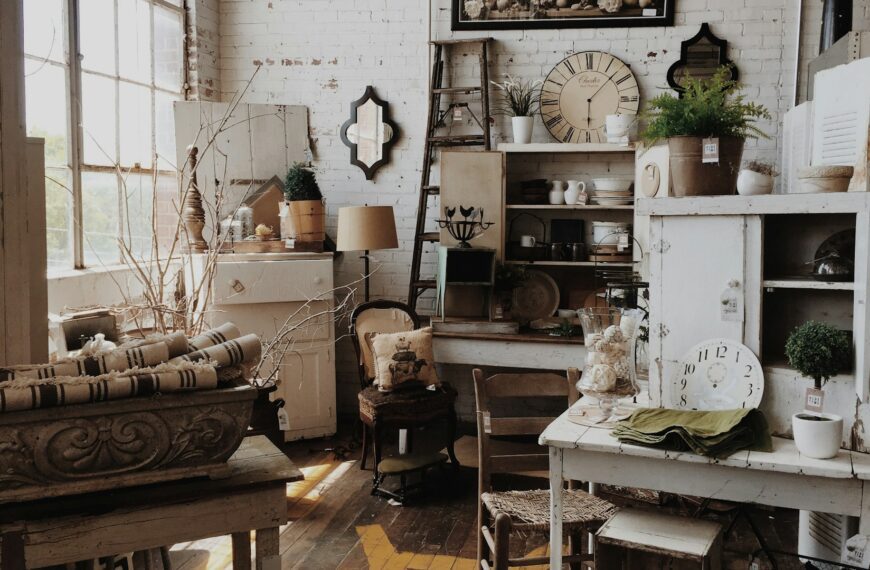 A white wooden cabinet and table fill a quiet vintage room.