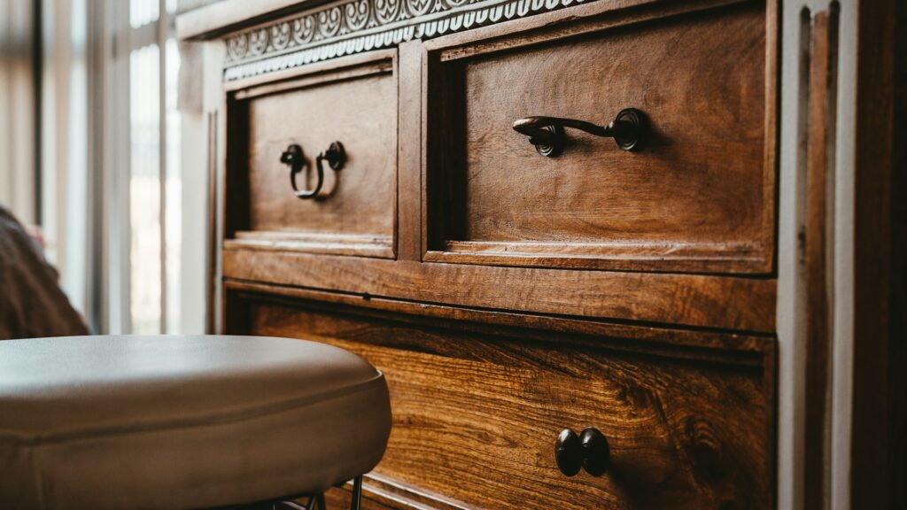 A brown wooden chest of drawers.