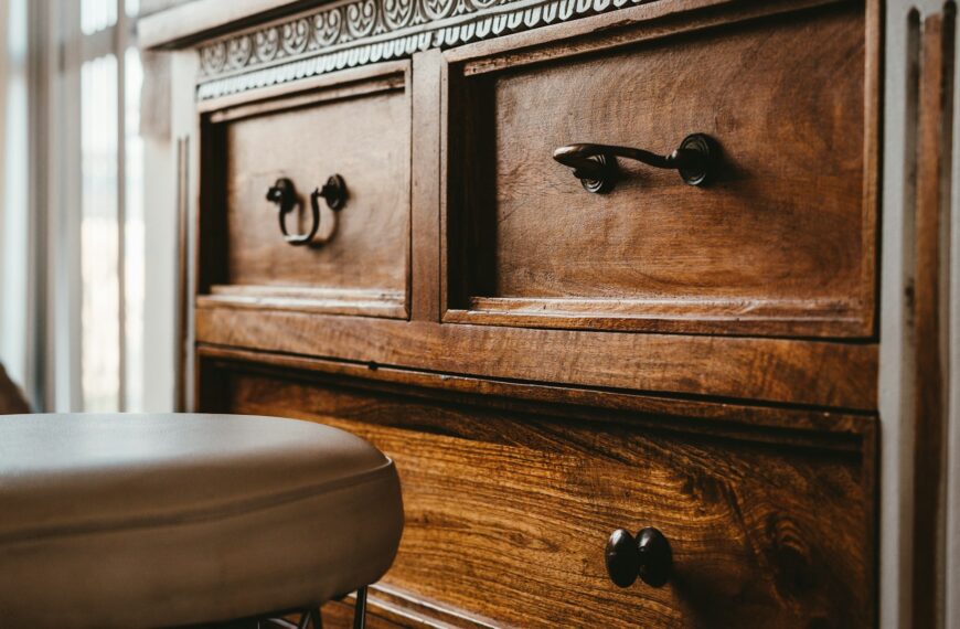 A brown wooden chest of drawers.