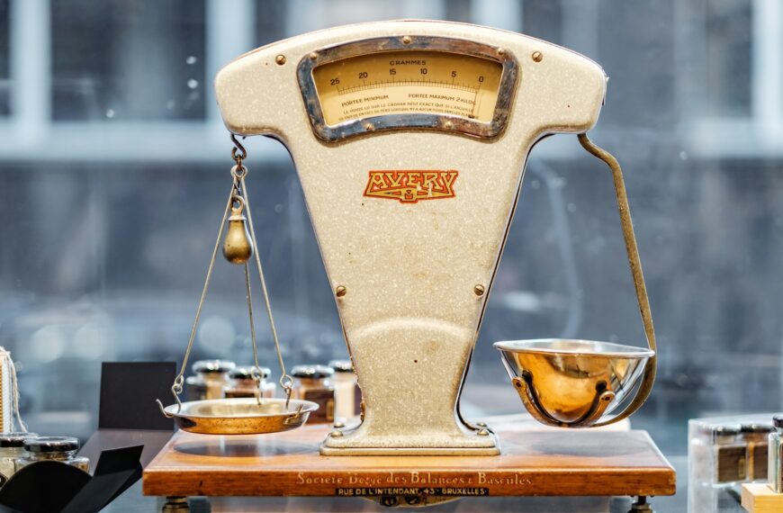 A small brown and beige weighing scale on a table.