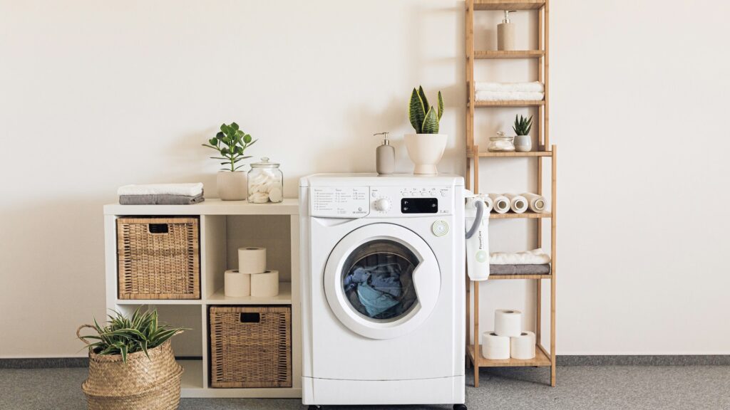 A washer and dryer stand side by side in a bright laundry room.