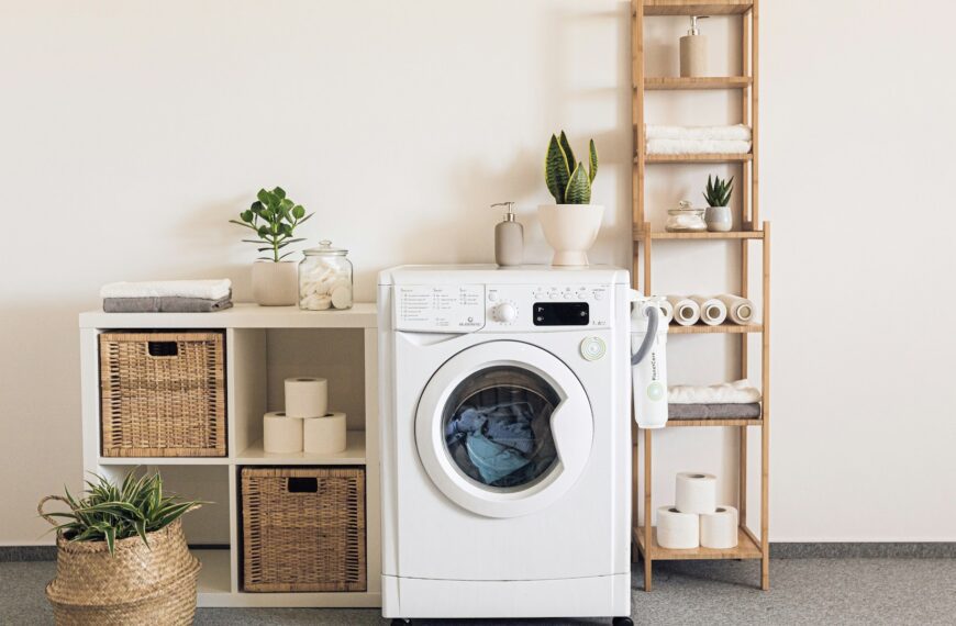 A washer and dryer stand side by side in a bright laundry room.