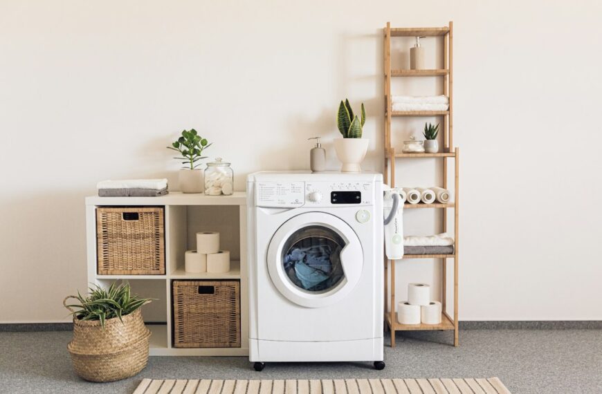 A laundry room with washer, dryer and basket