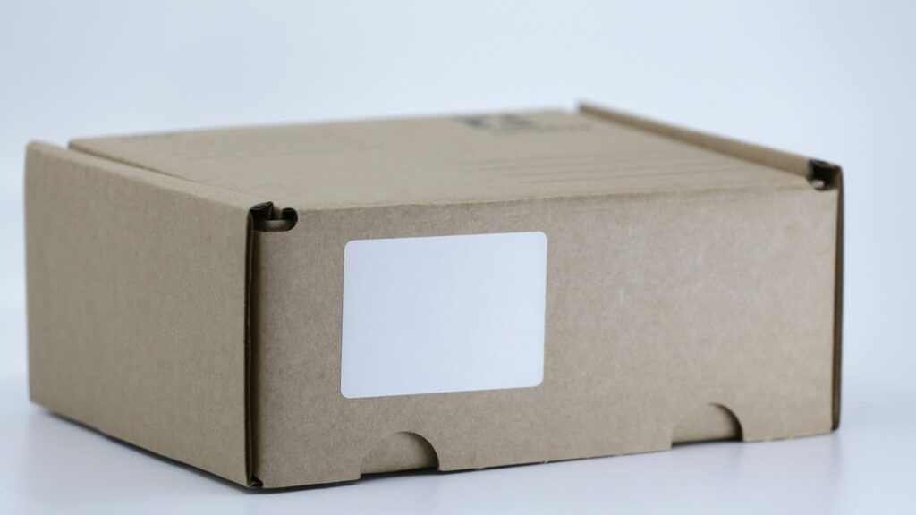 A brown cardboard shipping box sits on a white table.
