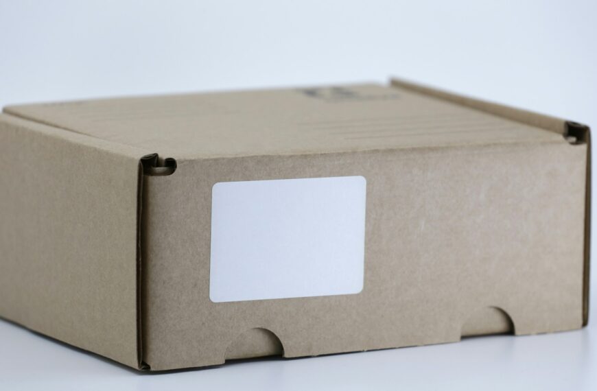 A brown cardboard shipping box sits on a white table.