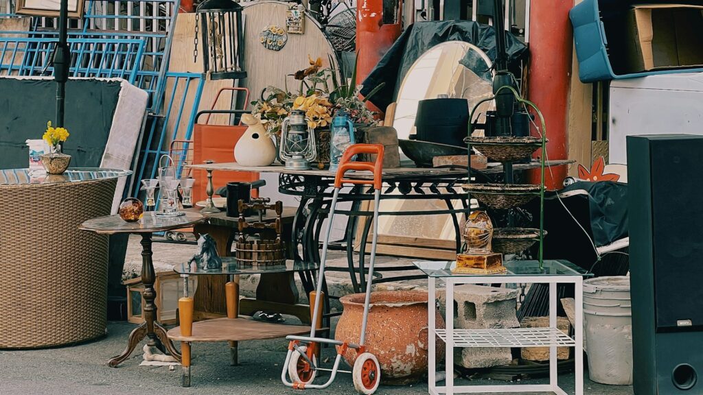 A pile of assorted household items set out for a garage sale.