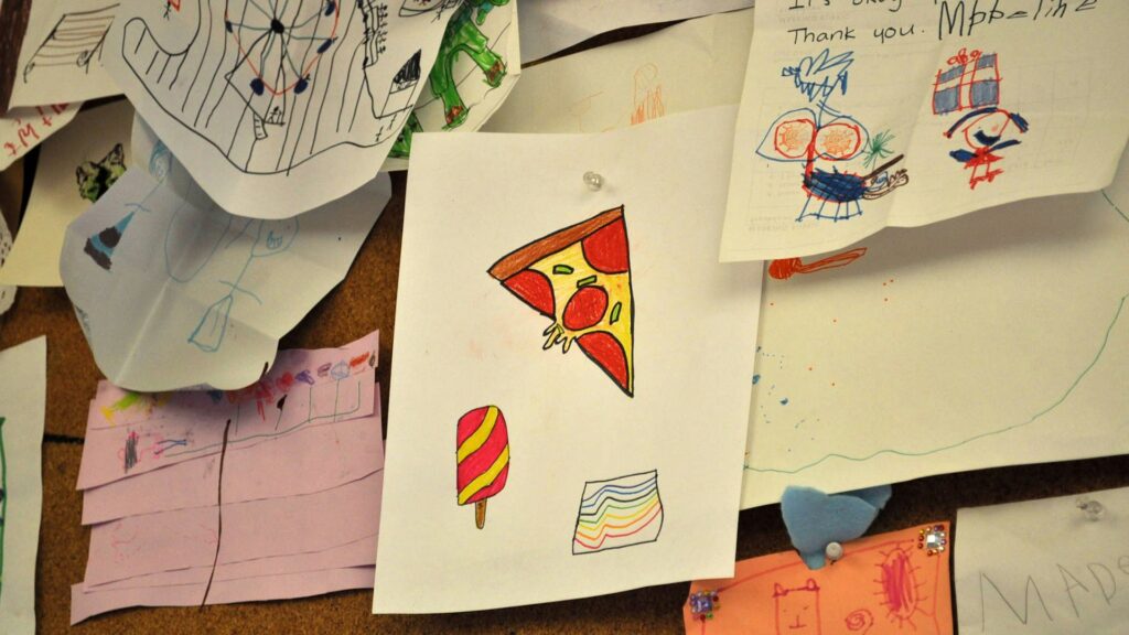 A bulletin board covered in layers of paper.