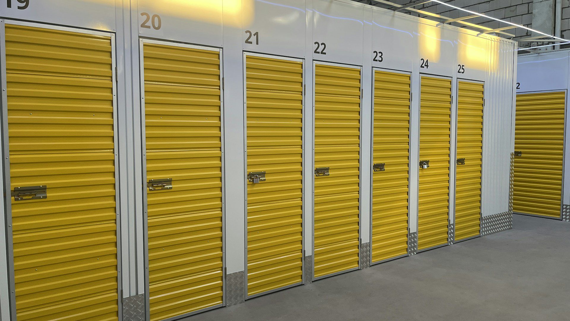 A row of storage units with yellow doors.