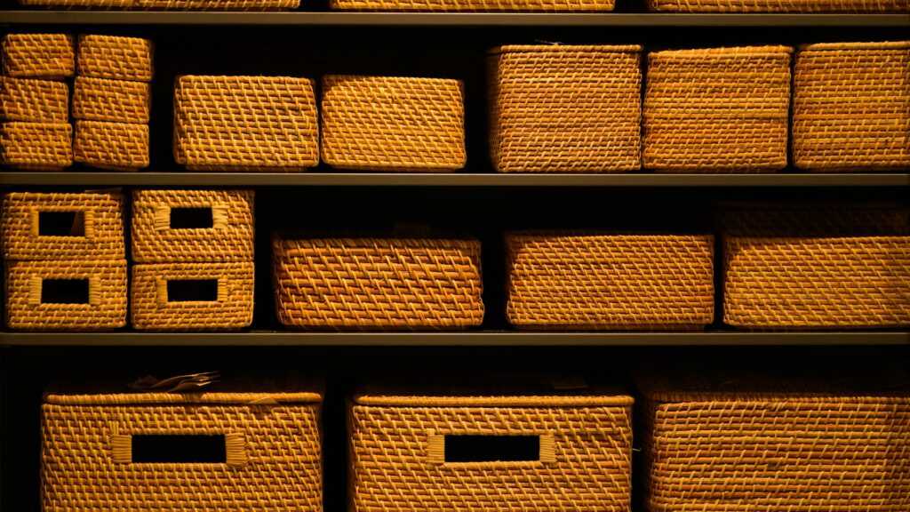 A shelf filled with neatly arranged wicker baskets.