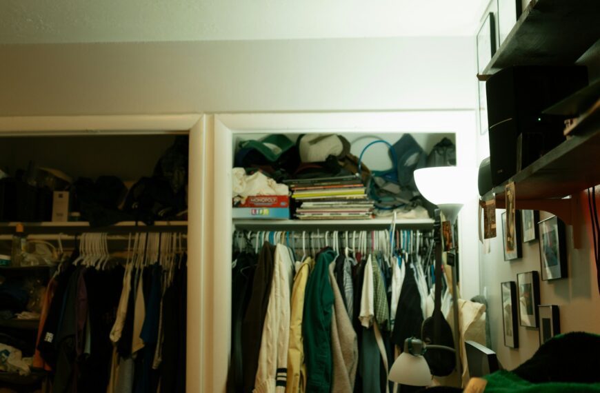 A crowded closet full of clothes and household items.