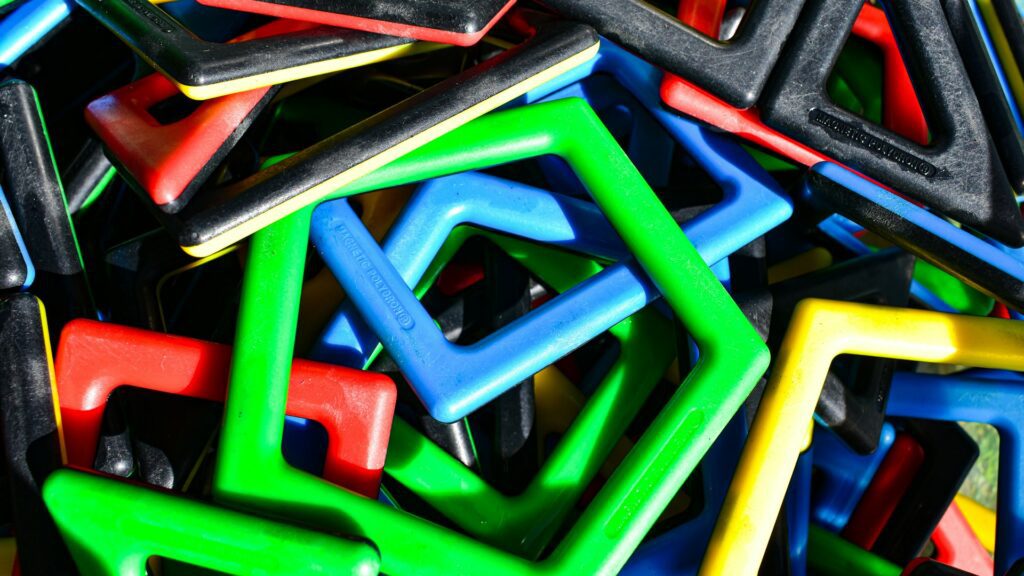 A pile of colorful geometric magnetic building toys.