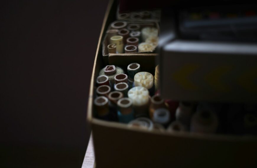 A vintage sewing basket with spools of thread